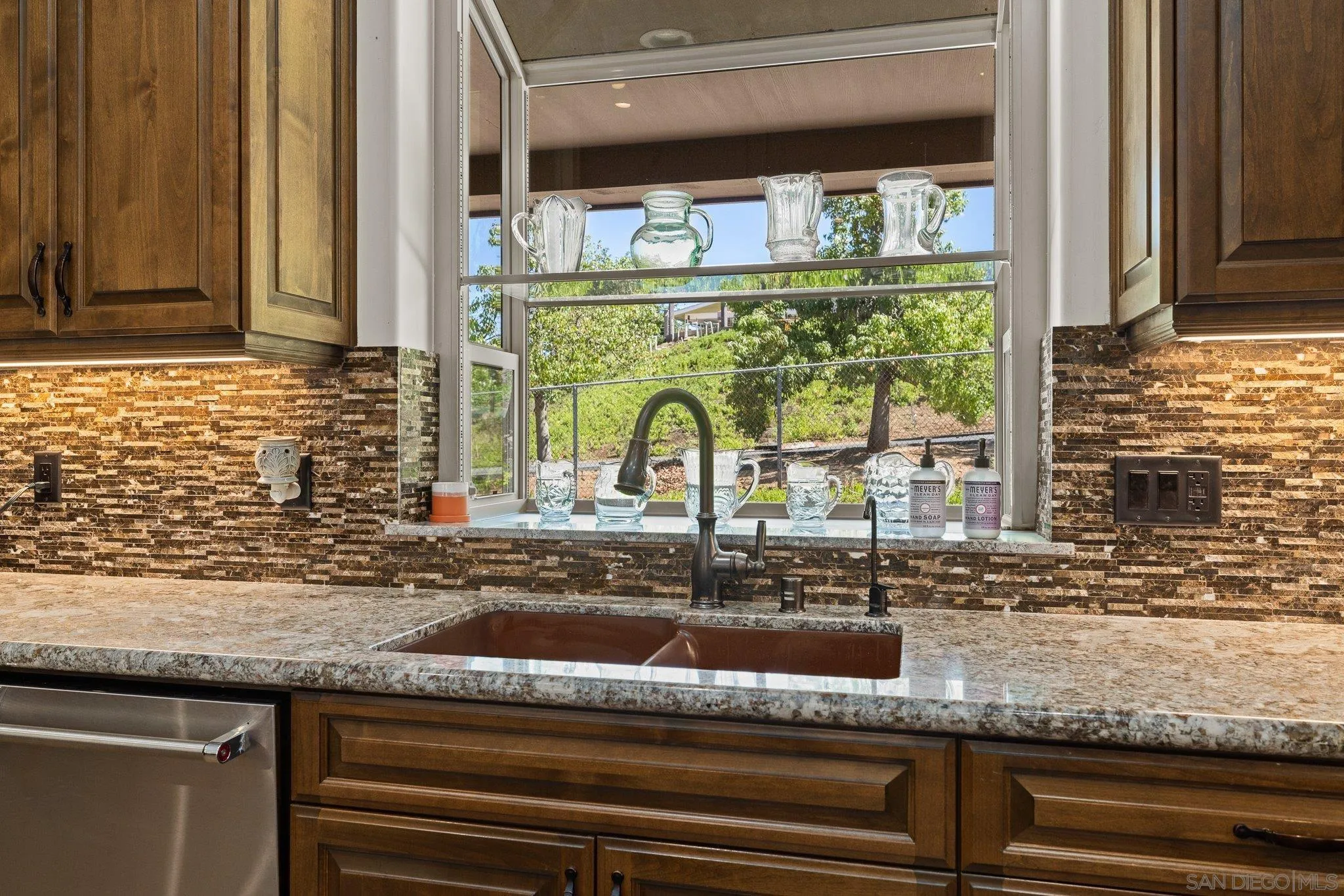 19553 Hidden Glen Road Alpine, CA 91901 - Photo 12 of 55 a kitchen sink with granite countertop a stove and a sink