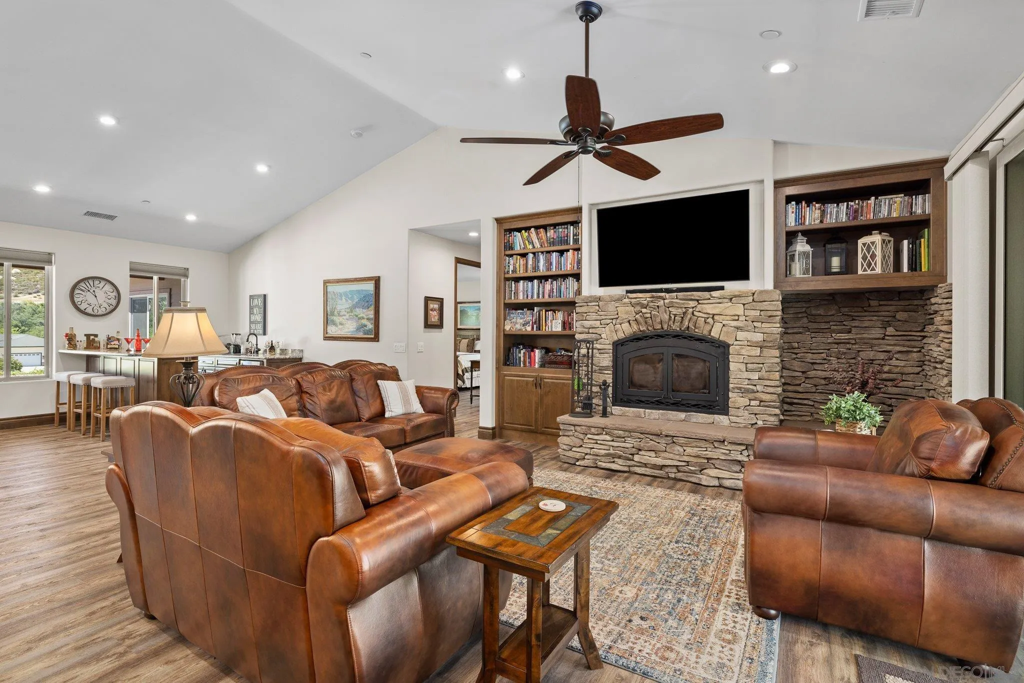 19553 Hidden Glen Road Alpine, CA 91901 - Photo 13 of 55 a living room with furniture a flat screen tv and a fireplace
