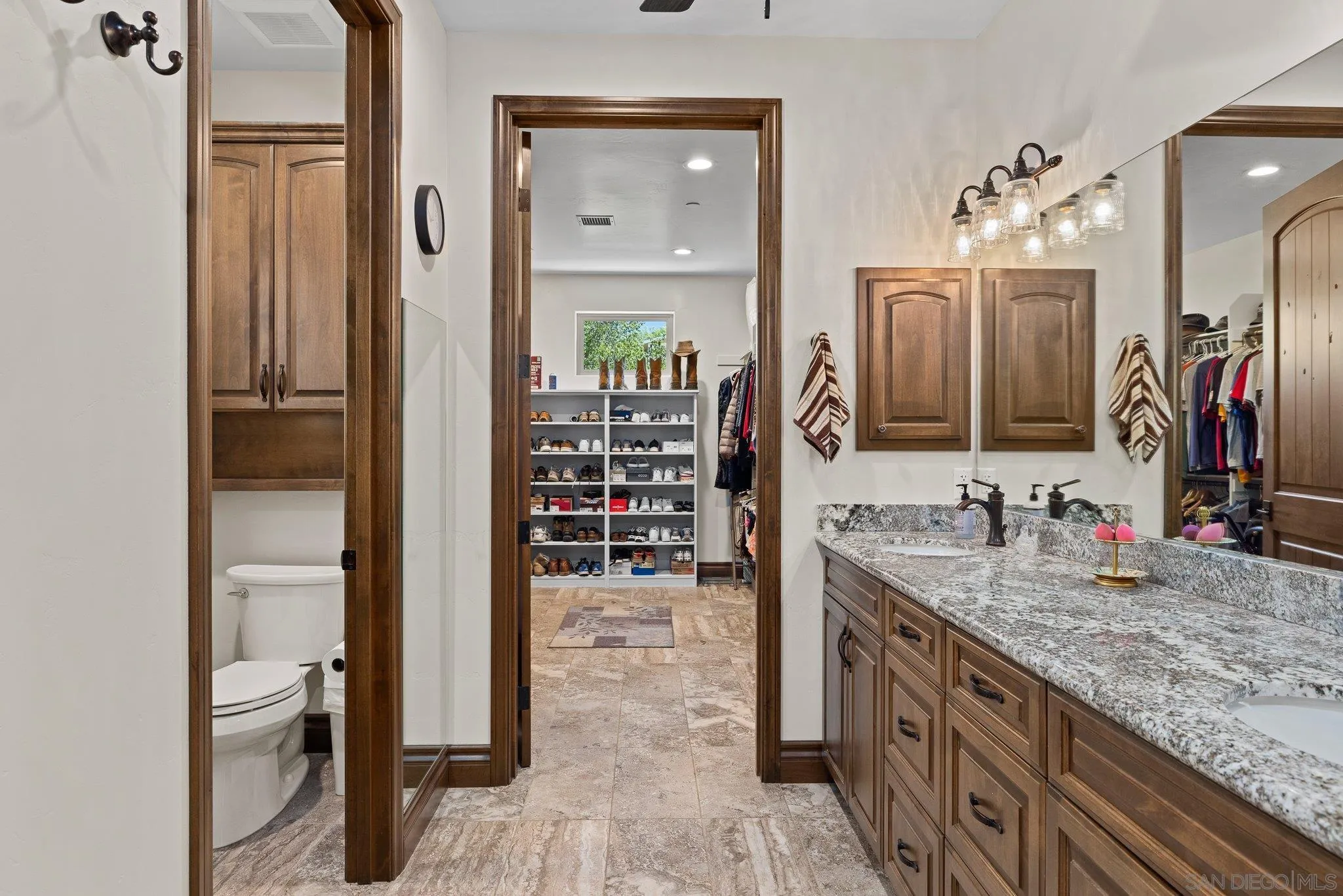 19553 Hidden Glen Road Alpine, CA 91901 - Photo 23 of 55 a bathroom with a granite countertop sink a mirror and a shower