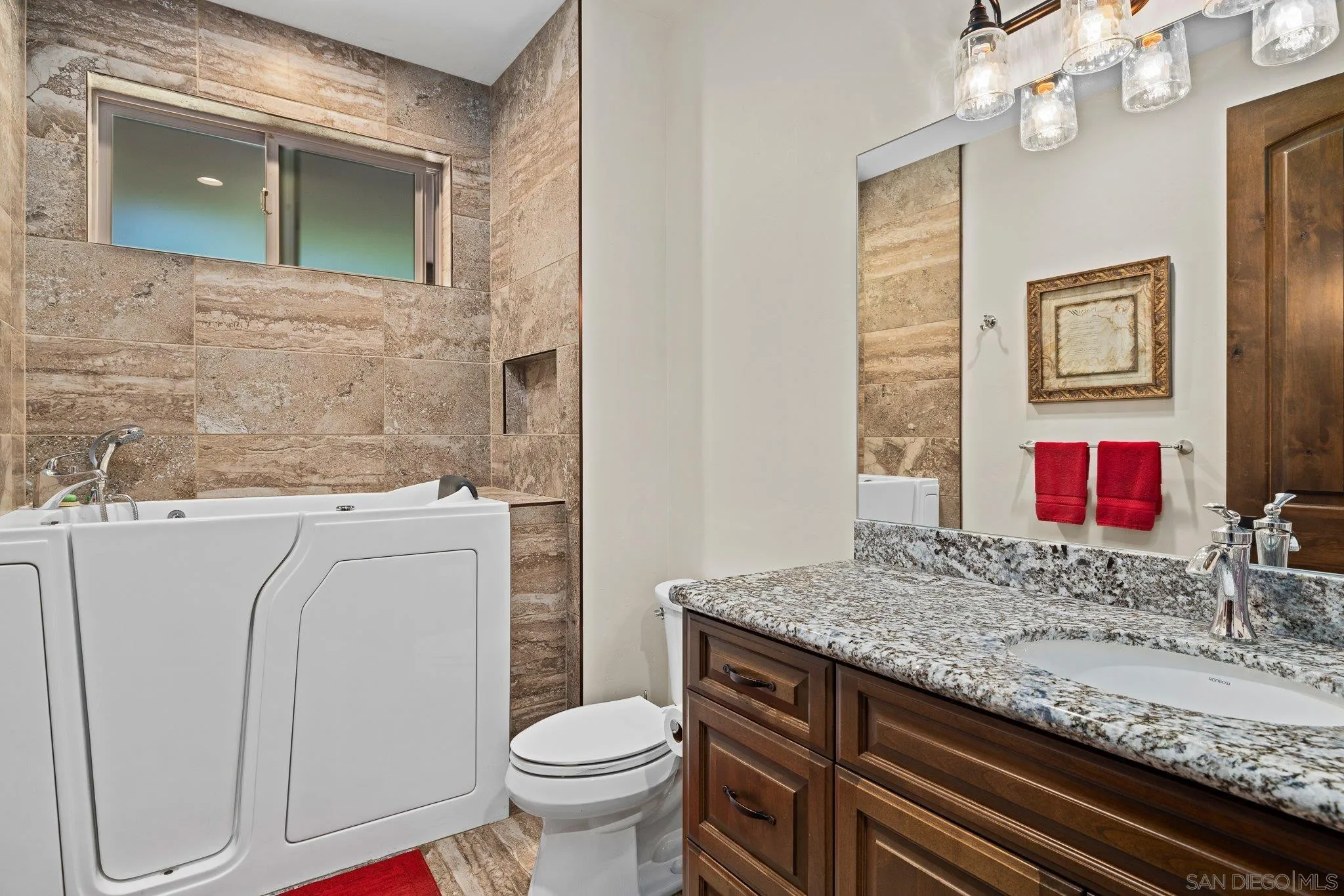 19553 Hidden Glen Road Alpine, CA 91901 - Photo 34 of 55 a bathroom with a granite countertop toilet sink and mirror