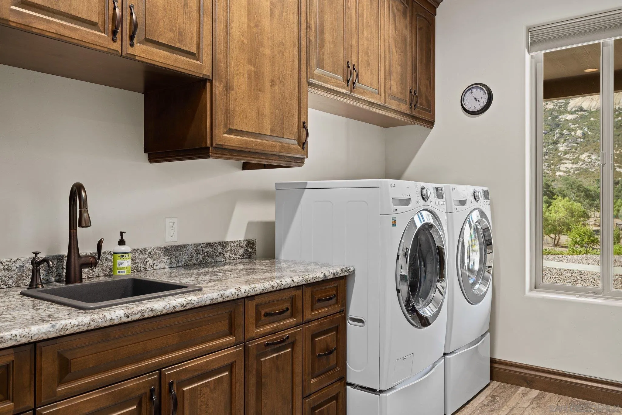 19553 Hidden Glen Road Alpine, CA 91901 - Photo 35 of 55 a utility room with sink dryer and washer