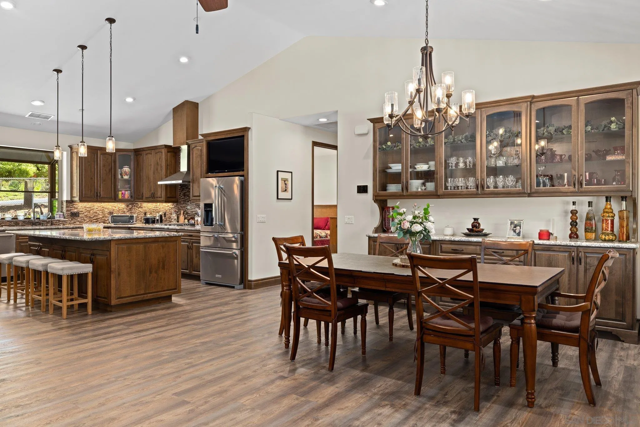19553 Hidden Glen Road Alpine, CA 91901 - Photo 7 of 55 a view of a dining room and livingroom with furniture wooden floor a chandelier