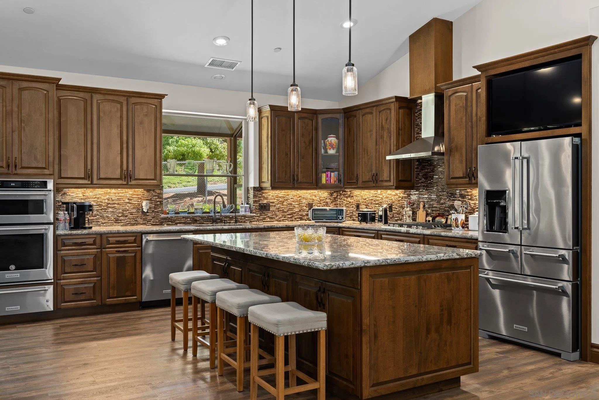 19553 Hidden Glen Road Alpine, CA 91901 - Photo 9 of 55 a kitchen with stainless steel appliances granite countertop a sink a stove and a refrigerator