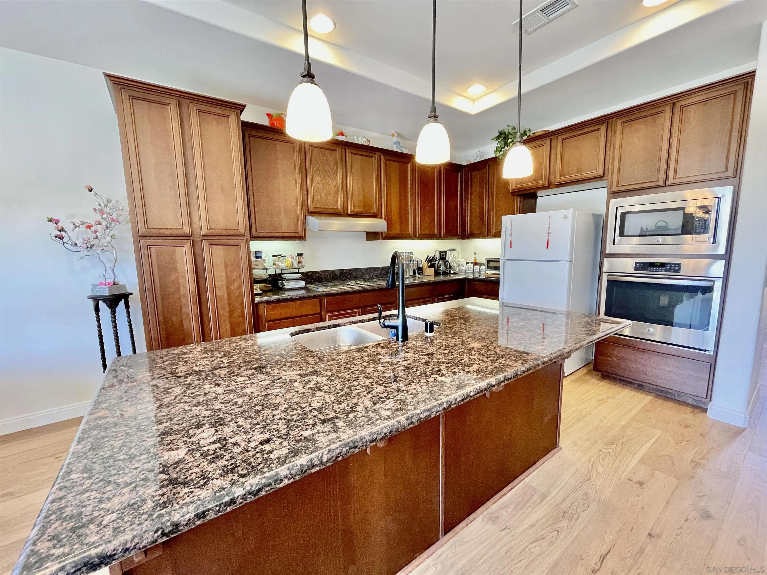 888 Rancho Terrace Ct. El Cajon, CA 92019 - Photo 14 of 34 a kitchen with stainless steel appliances granite countertop sink stove refrigerator and cabinets