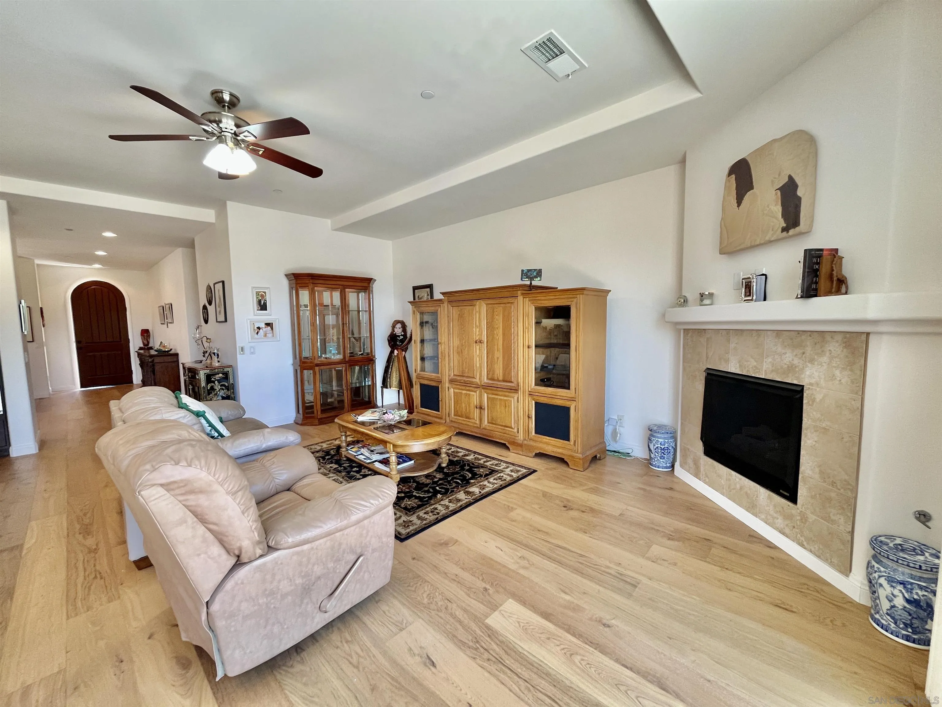 888 Rancho Terrace Ct. El Cajon, CA 92019 - Photo 18 of 34 a living room with furniture a fireplace and a flat screen tv