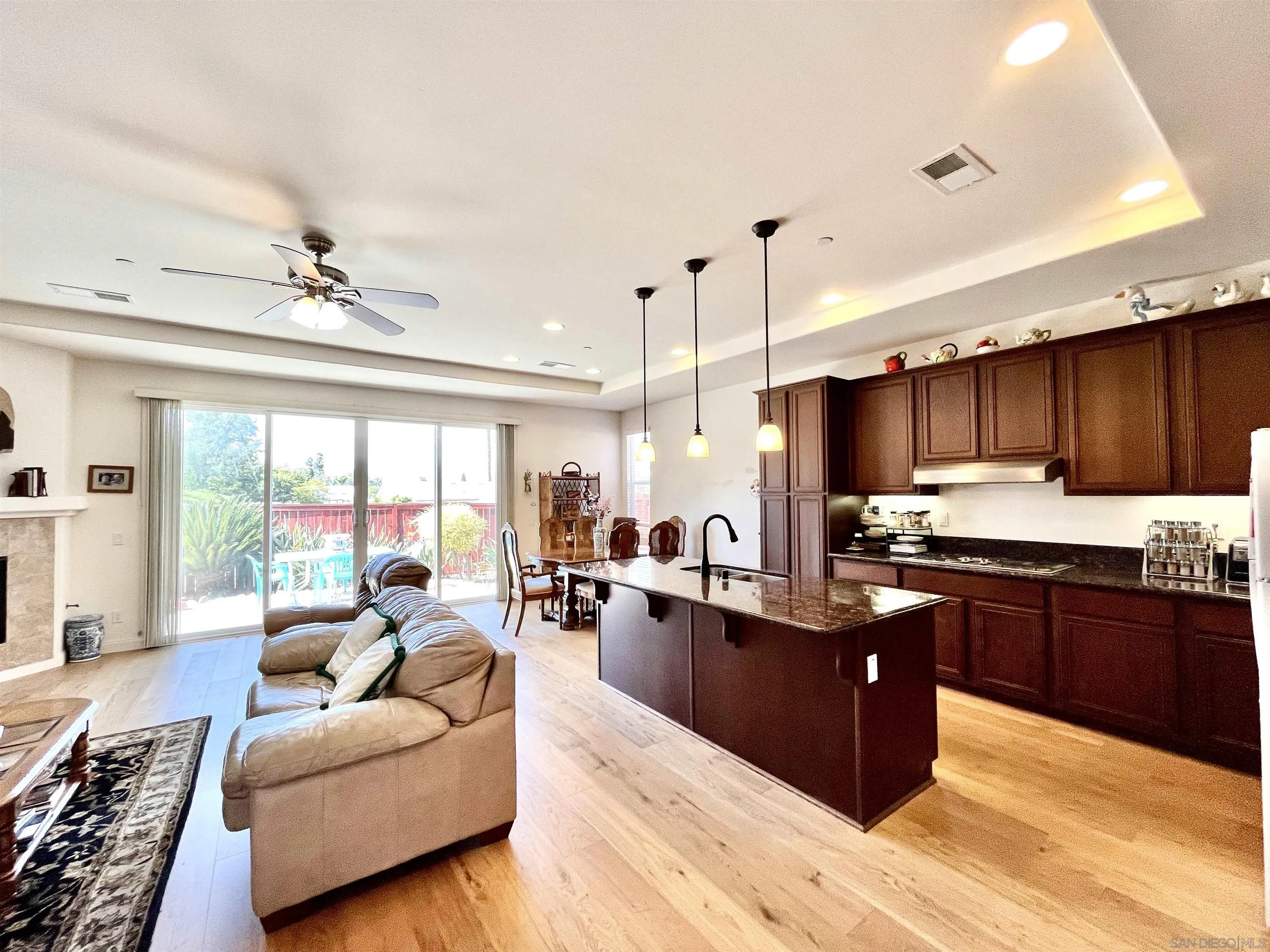 888 Rancho Terrace Ct. El Cajon, CA 92019 - Photo 19 of 34 a large kitchen with kitchen island a large counter top space a sink a stove and living room view