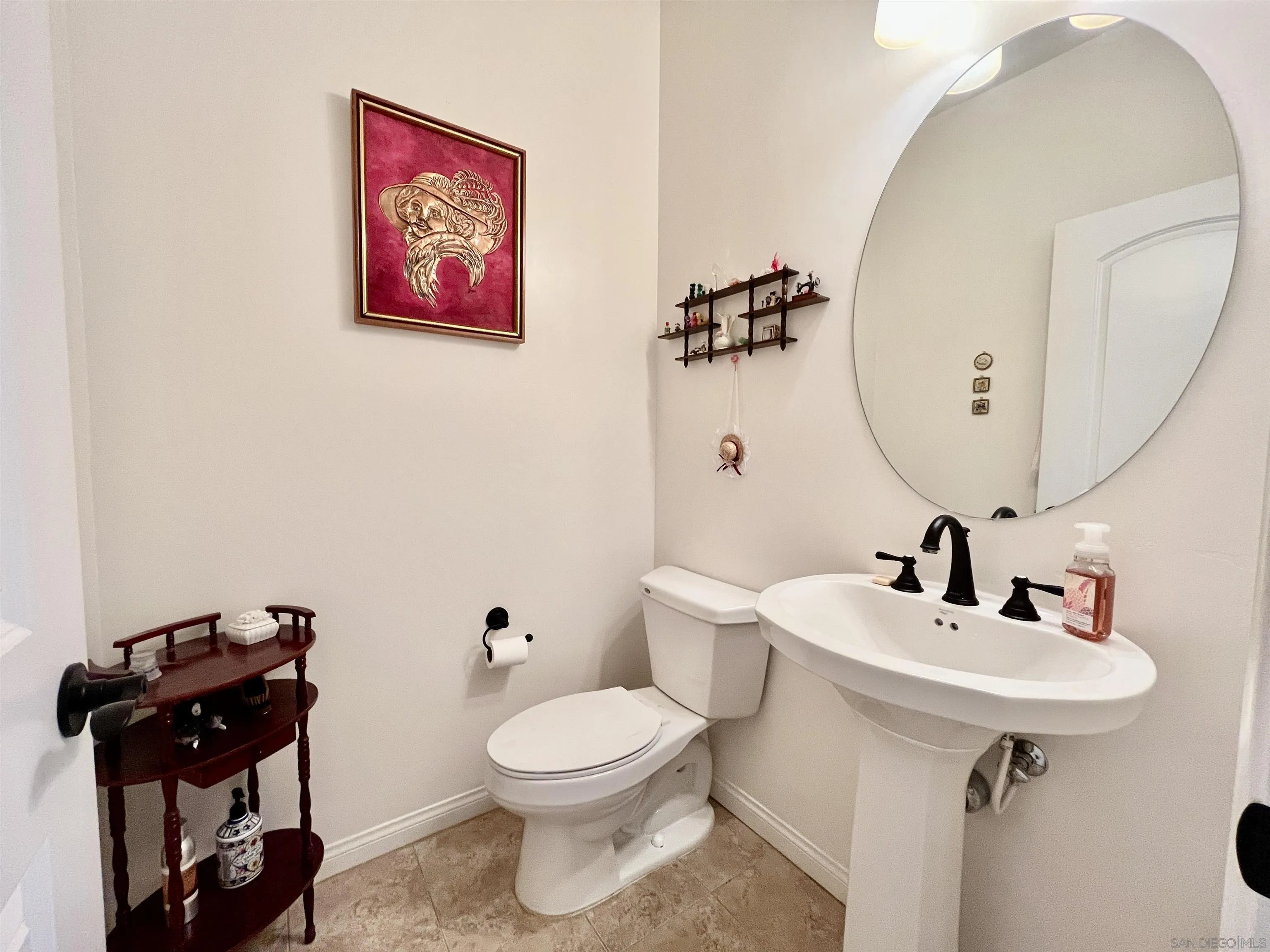 888 Rancho Terrace Ct. El Cajon, CA 92019 - Photo 20 of 34 a bathroom with a toilet a sink and mirror