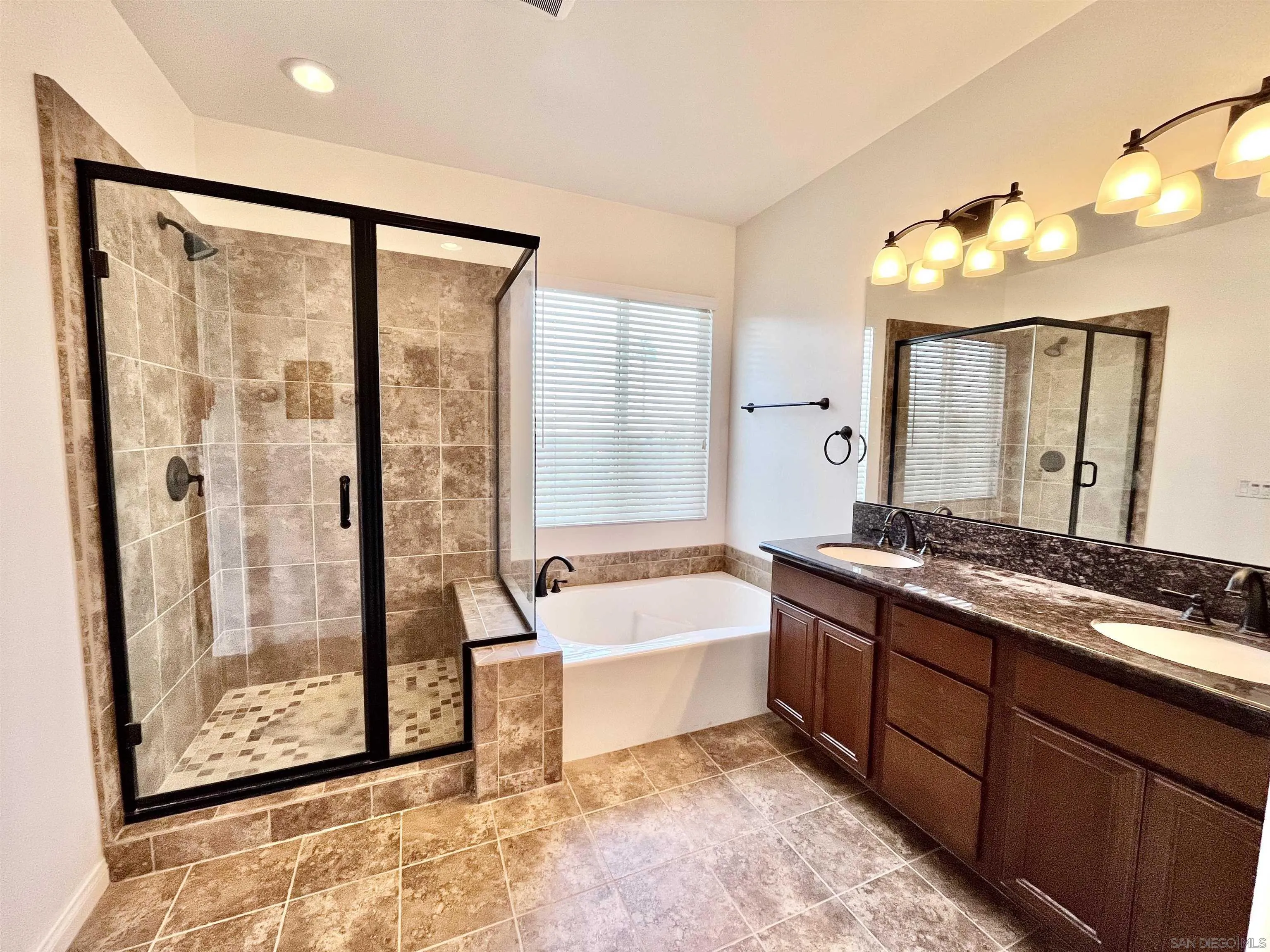 888 Rancho Terrace Ct. El Cajon, CA 92019 - Photo 27 of 34 a spacious bathroom with a tub sink shower and mirror