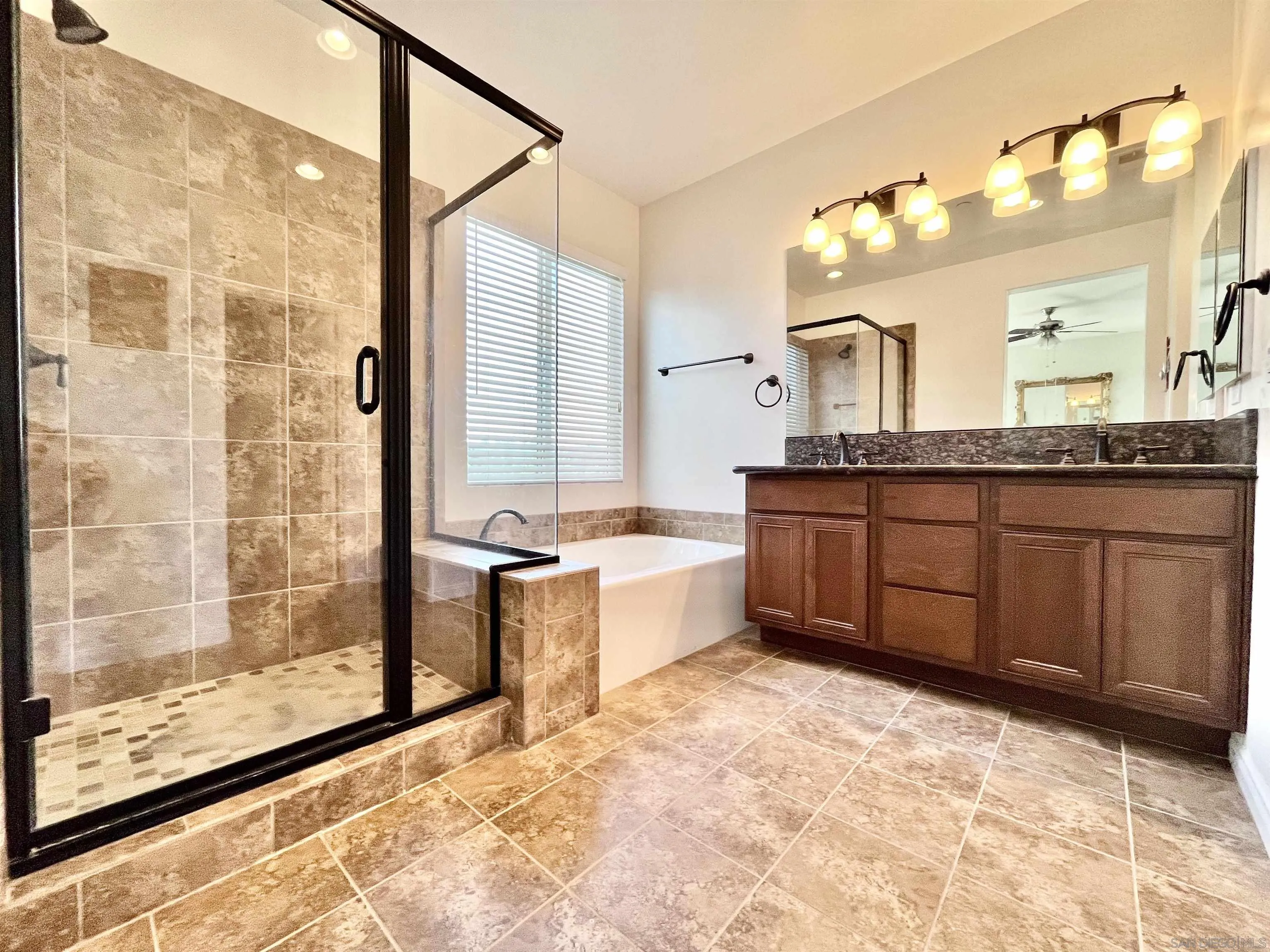 888 Rancho Terrace Ct. El Cajon, CA 92019 - Photo 28 of 34 a large bathroom with a tub sink shower and mirror