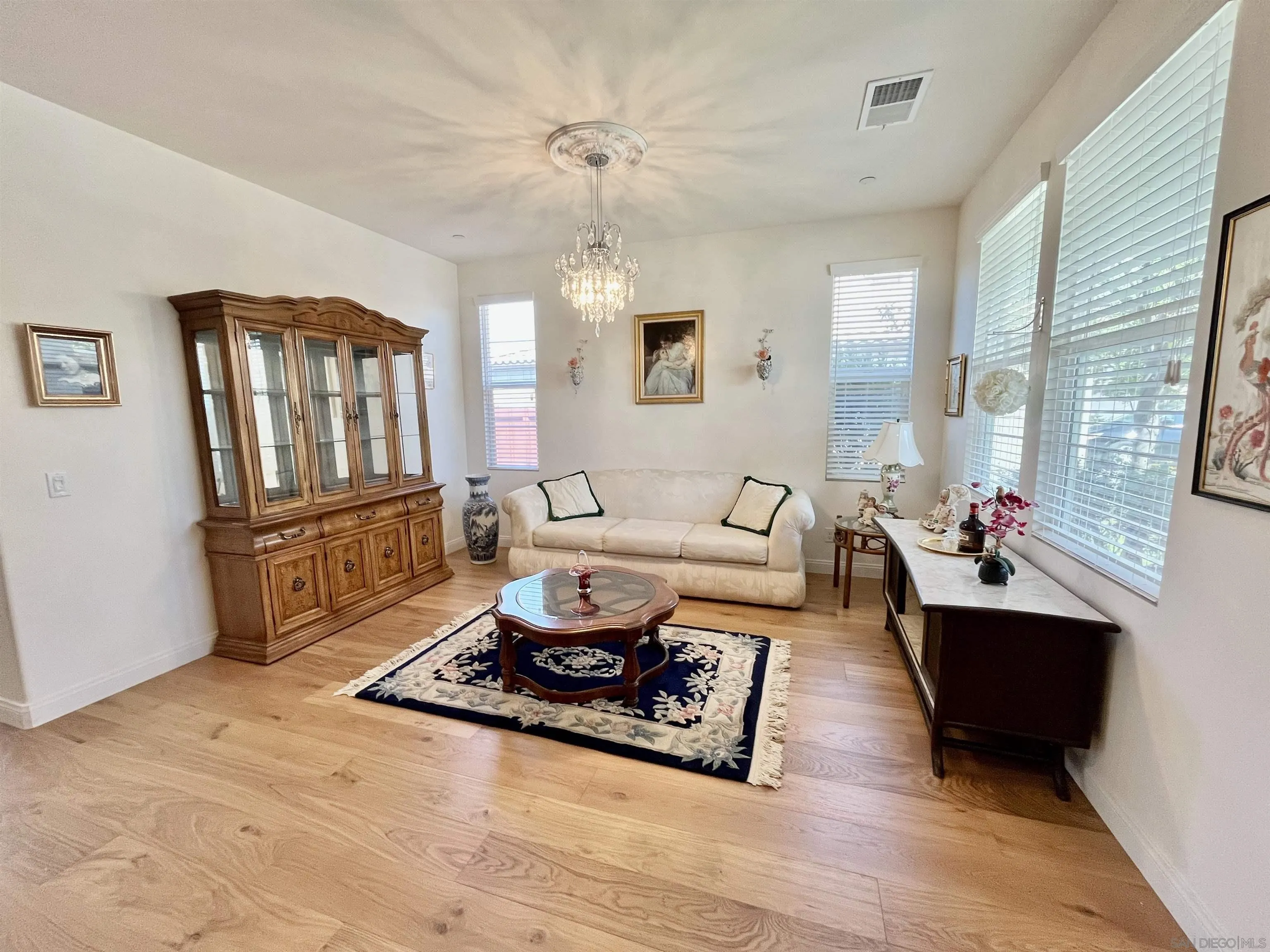 888 Rancho Terrace Ct. El Cajon, CA 92019 - Photo 9 of 34 a living room with furniture windows and a chandelier