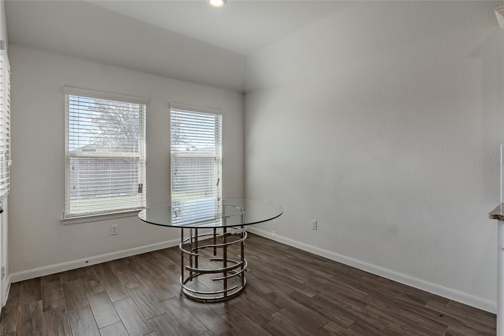 240 Copper Switch Drive Anna, TX 75409 - Photo 20 of 33 Unfurnished dining area with dark wood finished floors and vaulted ceiling