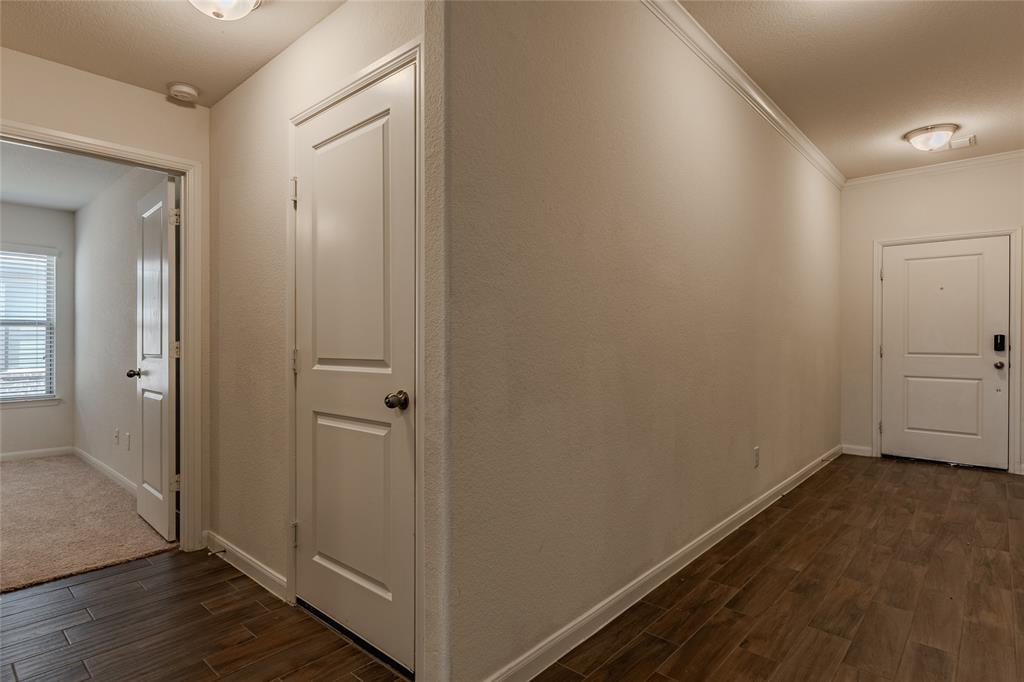 240 Copper Switch Drive Anna, TX 75409 - Photo 25 of 33 Hallway featuring dark wood-type flooring and crown molding