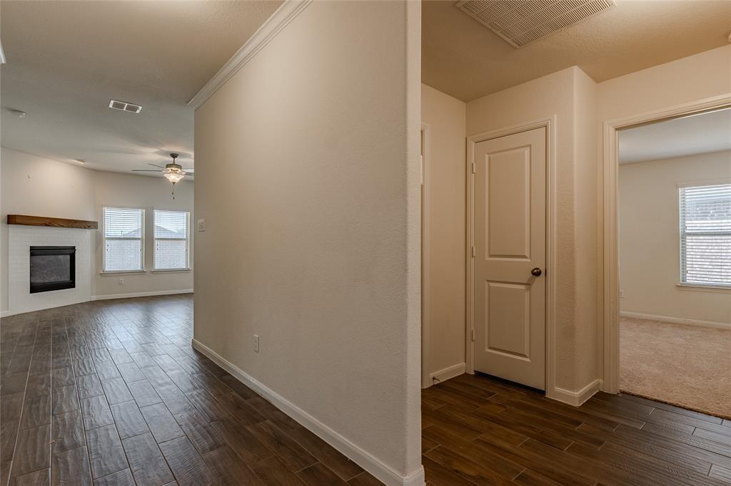 240 Copper Switch Drive Anna, TX 75409 - Photo 26 of 33 Hallway featuring dark wood-style flooring and baseboards