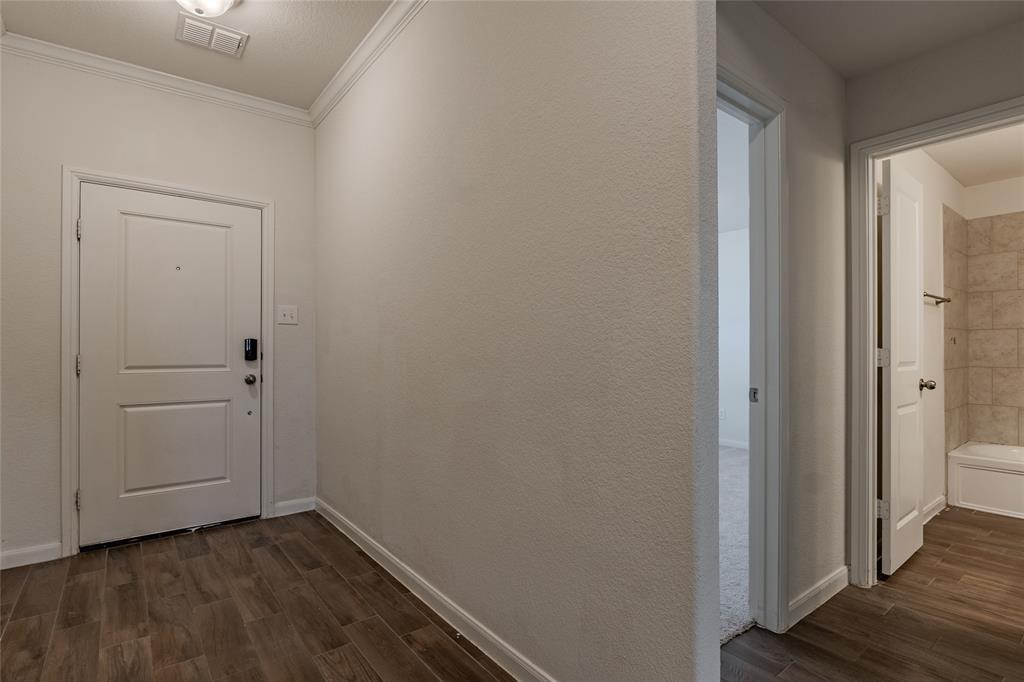 240 Copper Switch Drive Anna, TX 75409 - Photo 4 of 33 Hallway with dark wood-type flooring and ornamental molding