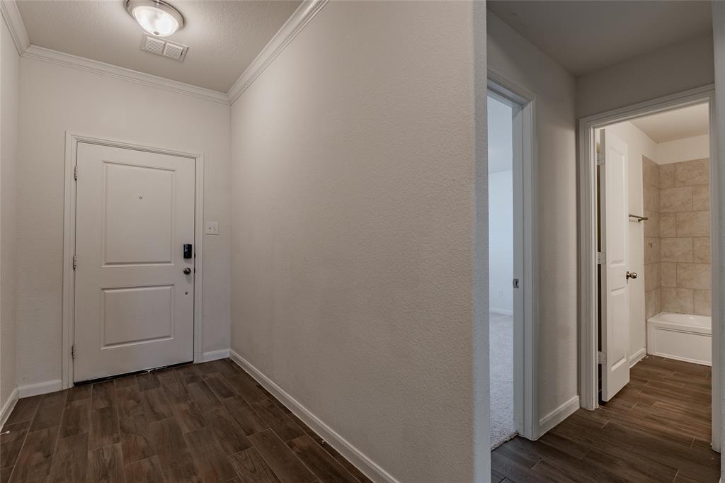 240 Copper Switch Drive Anna, TX 75409 - Photo 5 of 33 Corridor with dark wood finished floors and crown molding