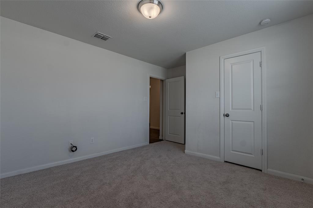 240 Copper Switch Drive Anna, TX 75409 - Photo 7 of 33 Unfurnished bedroom featuring light carpet and baseboards