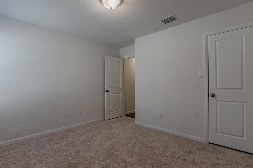 240 Copper Switch Drive Anna, TX 75409 - Photo 9 of 33 Unfurnished bedroom featuring carpet and baseboards