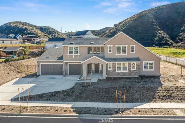 a aerial view of a house next to a mountain
