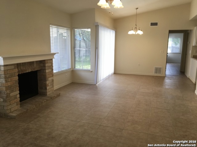 16619 Crested Butte Street San Antonio, TX 78247 - Photo 2 of 5 an empty room with windows and fireplace