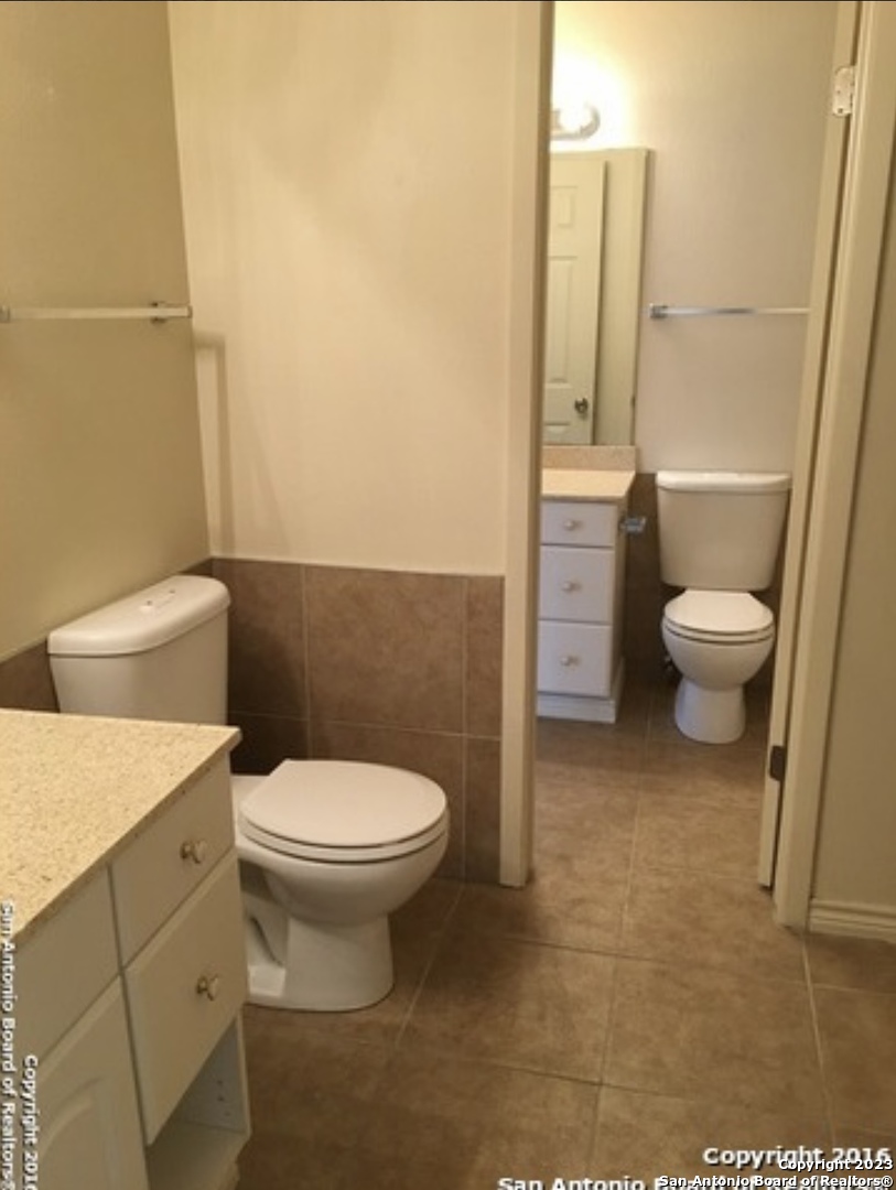 16619 Crested Butte Street San Antonio, TX 78247 - Photo 3 of 5 a white toilet sitting next to a bathroom sink