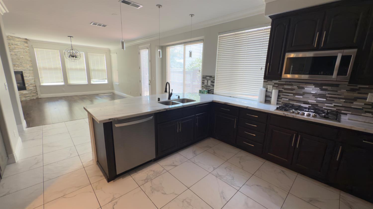 11816 Spring Walk Way Rancho Cordova, CA 95742 - Photo 12 of 36 a kitchen with a sink stove and microwave