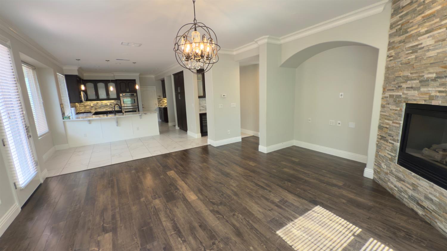 11816 Spring Walk Way Rancho Cordova, CA 95742 - Photo 16 of 36 an empty room with wooden floor fireplace and windows