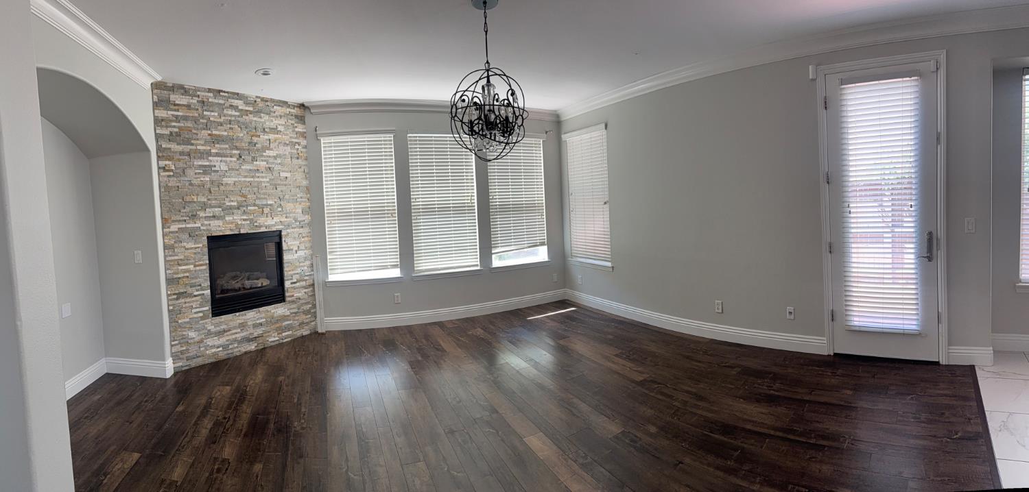 11816 Spring Walk Way Rancho Cordova, CA 95742 - Photo 17 of 36 a view of empty room with wooden floor and fireplace