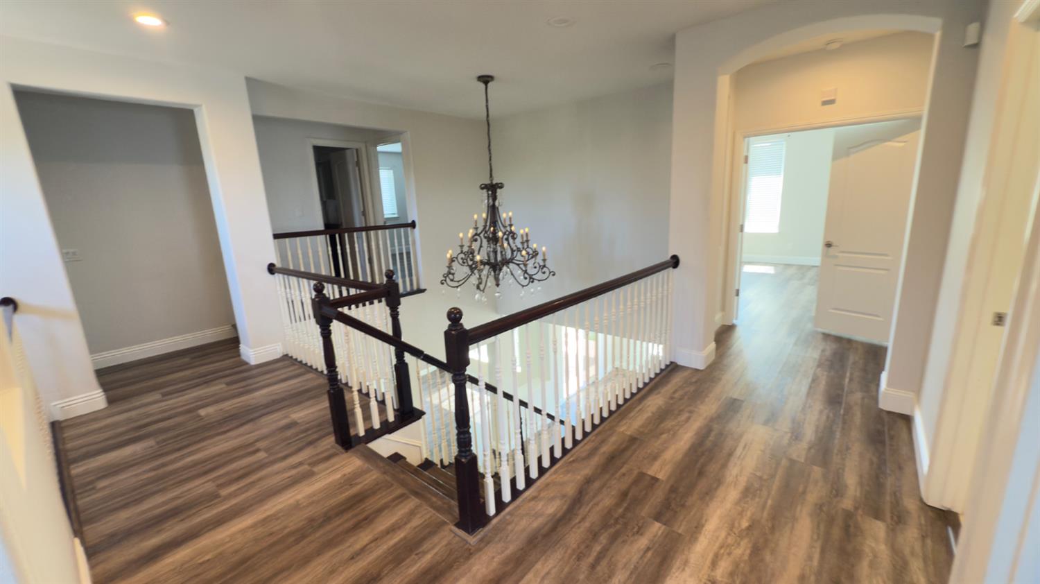 11816 Spring Walk Way Rancho Cordova, CA 95742 - Photo 19 of 36 a view of a hallway with wooden floor and stairs