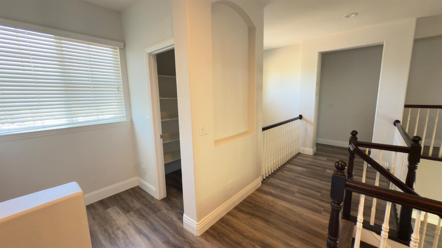 11816 Spring Walk Way Rancho Cordova, CA 95742 - Photo 22 of 36 a view of a hallway with wooden floor and stairs