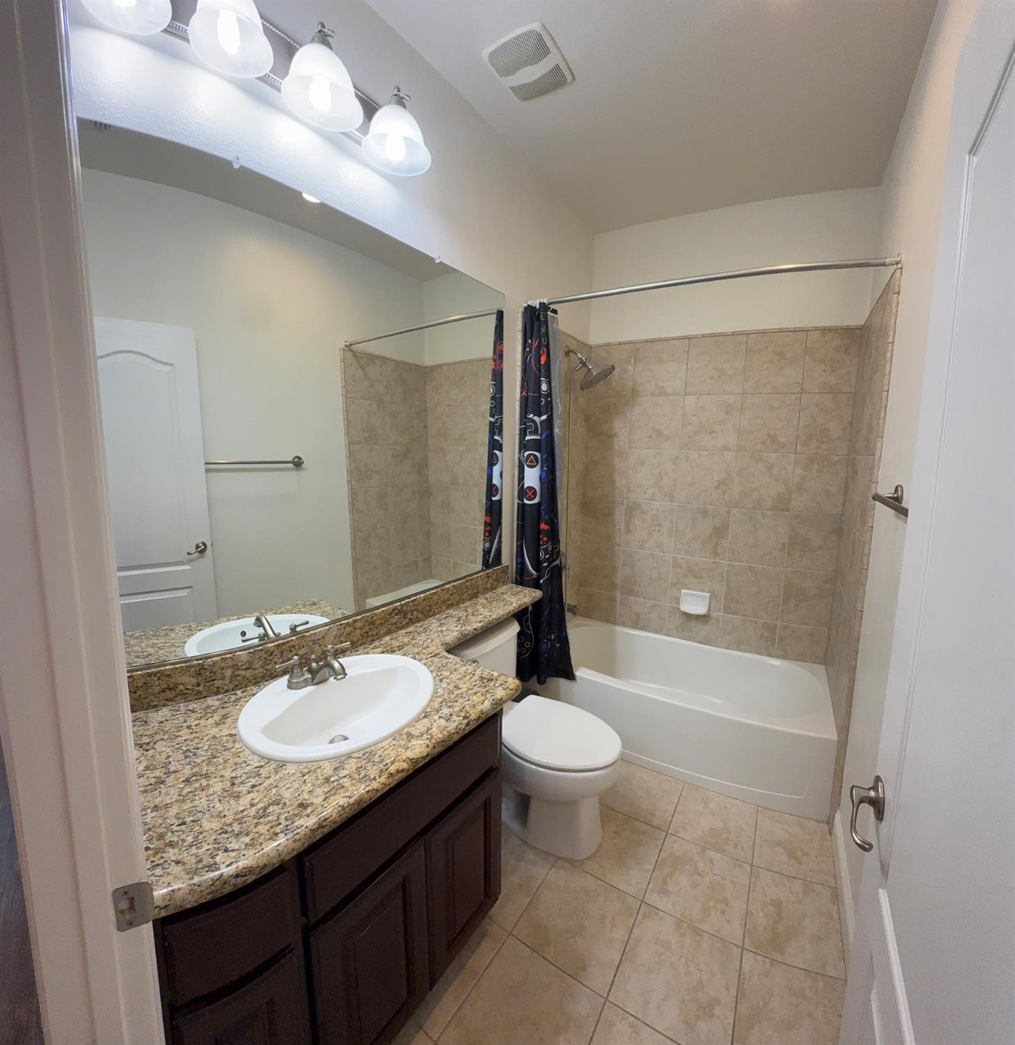 11816 Spring Walk Way Rancho Cordova, CA 95742 - Photo 24 of 36 a bathroom with a granite countertop sink toilet mirror and bathtub