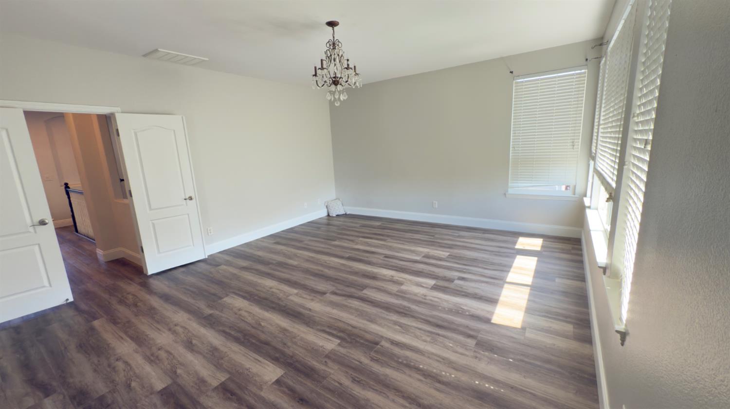11816 Spring Walk Way Rancho Cordova, CA 95742 - Photo 25 of 36 a view of a room with wooden floor and white walls