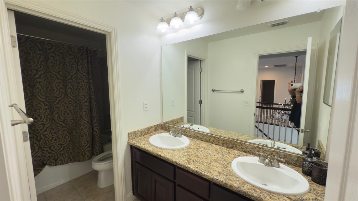 11816 Spring Walk Way Rancho Cordova, CA 95742 - Photo 29 of 36 a bathroom with a granite countertop sink and a mirror