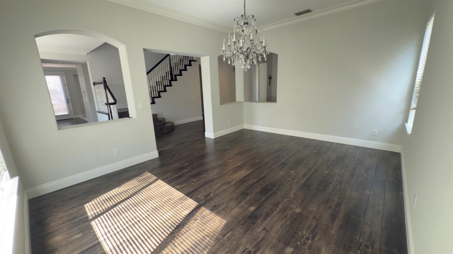 11816 Spring Walk Way Rancho Cordova, CA 95742 - Photo 6 of 36 a view of a hallway with wooden floor and a chandelier