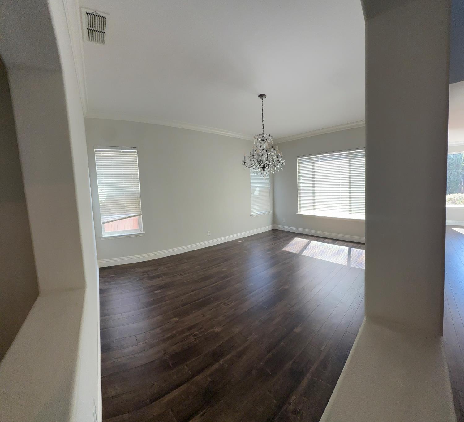 11816 Spring Walk Way Rancho Cordova, CA 95742 - Photo 9 of 36 an empty room with wooden floor chandelier and windows