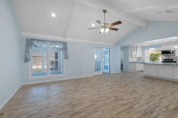 a kitchen with stainless steel appliances granite countertop a stove a sink and a microwave