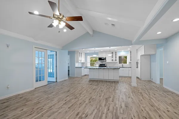 a kitchen with granite countertop wooden cabinets and a sink