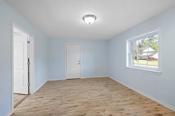 a bathroom with a granite countertop sink and mirror with bathtub