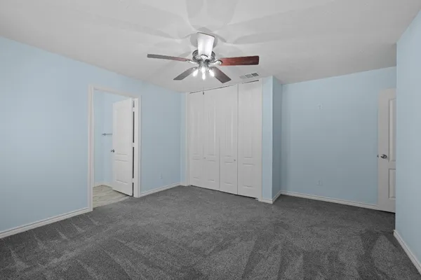a bathroom with a granite countertop double vanity sink and a mirror