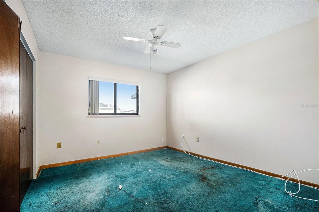 10080 Southwest 99th Avenue Ocala, FL 34481 - Photo 13 of 15 an empty room with a ceiling fan and window