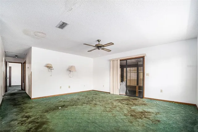 an empty room with closet and windows