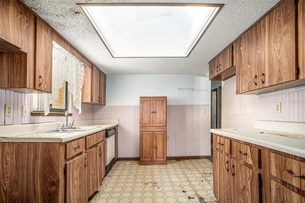 10080 Southwest 99th Avenue Ocala, FL 34481 - Photo 5 of 15 a kitchen with stainless steel appliances granite countertop a sink stove and refrigerator