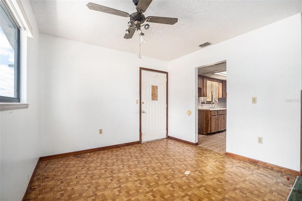 10080 Southwest 99th Avenue Ocala, FL 34481 - Photo 7 of 15 a view of a room with a stylish ceiling fan and entryway