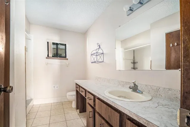 a bathroom with a sink a toilet and mirror