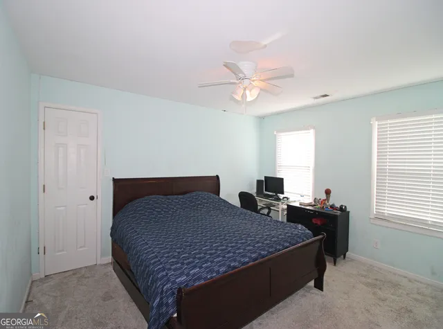 a bedroom with a bed and a table in it