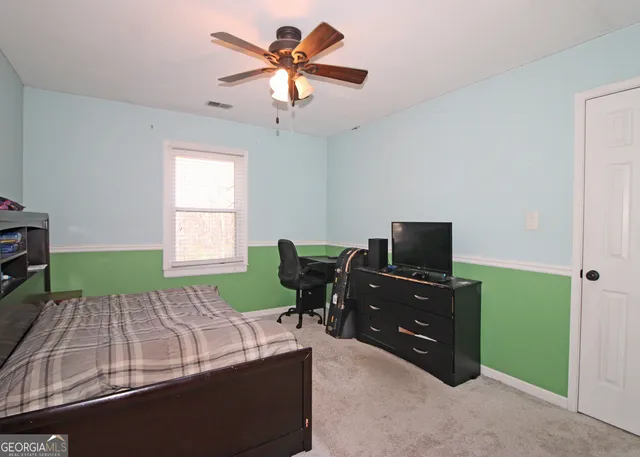 a bedroom with a bed and a tv