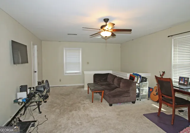 a living room with furniture a dining table and a window