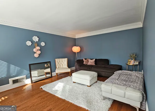 a living room with furniture and a lamp