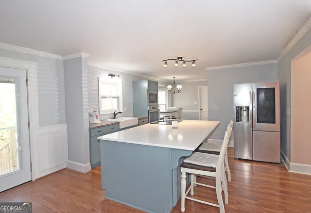 a large white kitchen with a large window