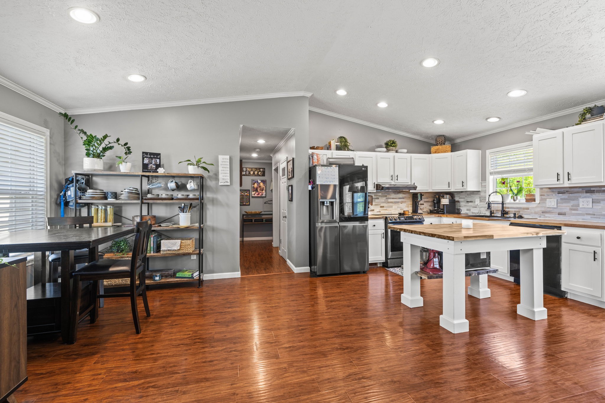 1154 Wrights Mill Road Spring Hill, TN 37174 - Photo 15 of 38 a kitchen with stainless steel appliances kitchen island granite countertop a table chairs and a refrigerator