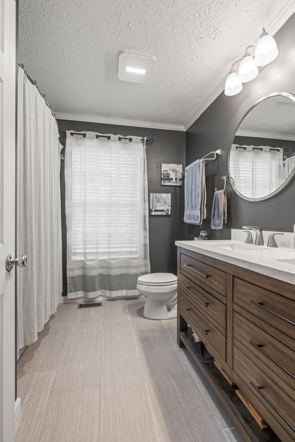 1154 Wrights Mill Road Spring Hill, TN 37174 - Photo 21 of 38 a bathroom with a double vanity sink toilet mirror and window